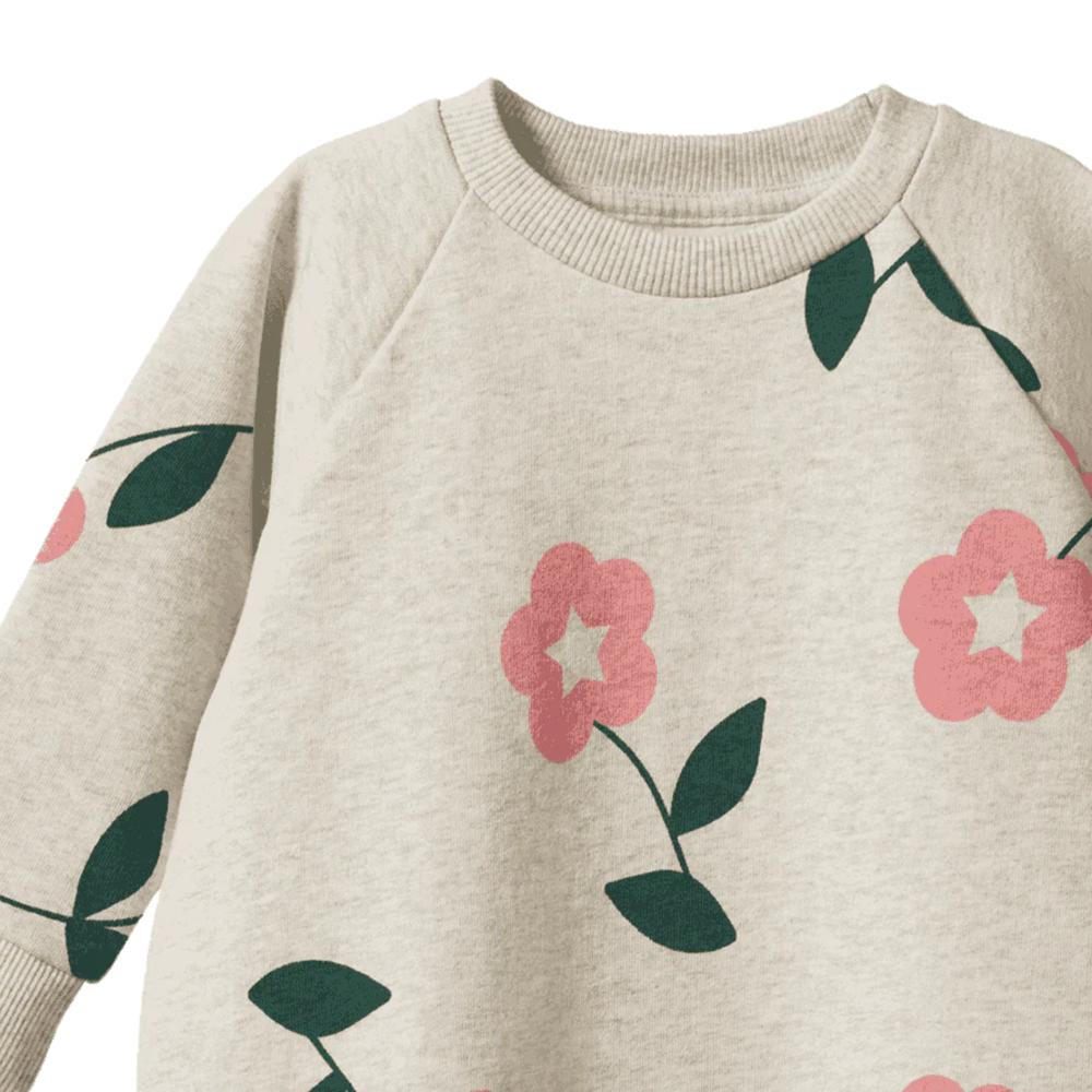 Beige sweater with pink floral patterns on a white background