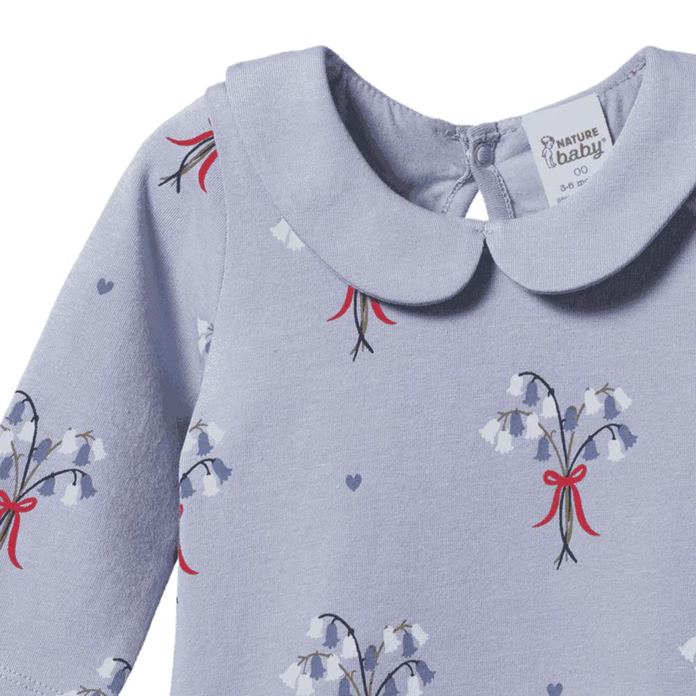 Baby onesie with collar with floral bluebell pattern and red bows on a white background