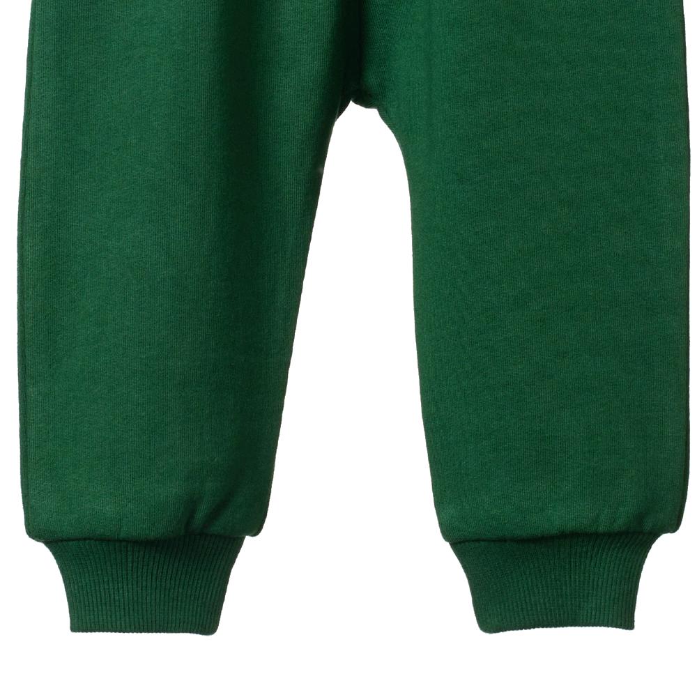 Close up of the cuffs of a pair of Green cotton trackpants on a white background