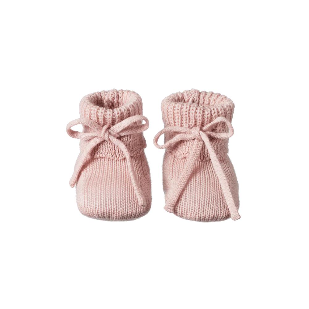 Pair of pink knitted baby booties with knitted ribbons on a white background