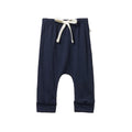 Merino wool navy blue baby pants with a white drawstring on a white background