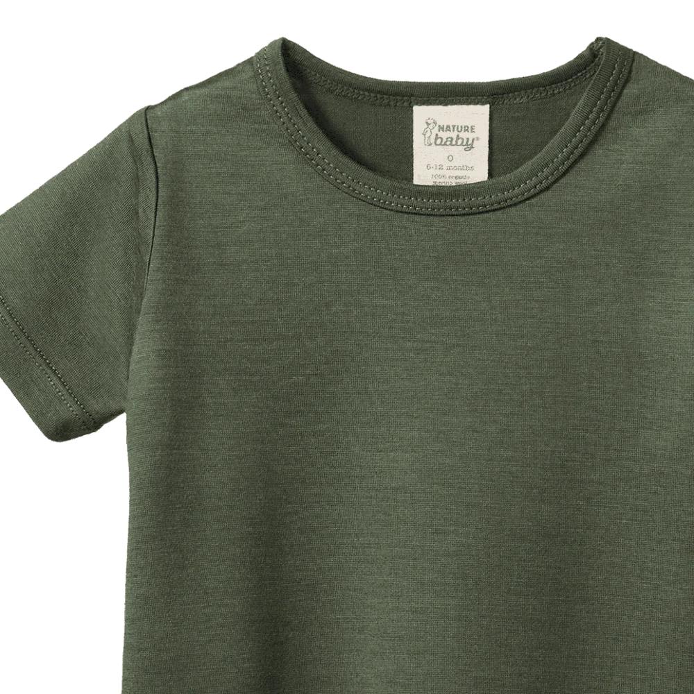 Forest green merino wool t-shirt with a visible Nature Baby brand label on a white background