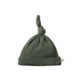 Green knotted baby hat in a merino pointelle fabric on a white background