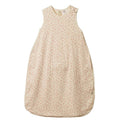 A sleeveless baby sleep bag in a light cream color with a tiny pink floral pattern, laid flat against a white background.