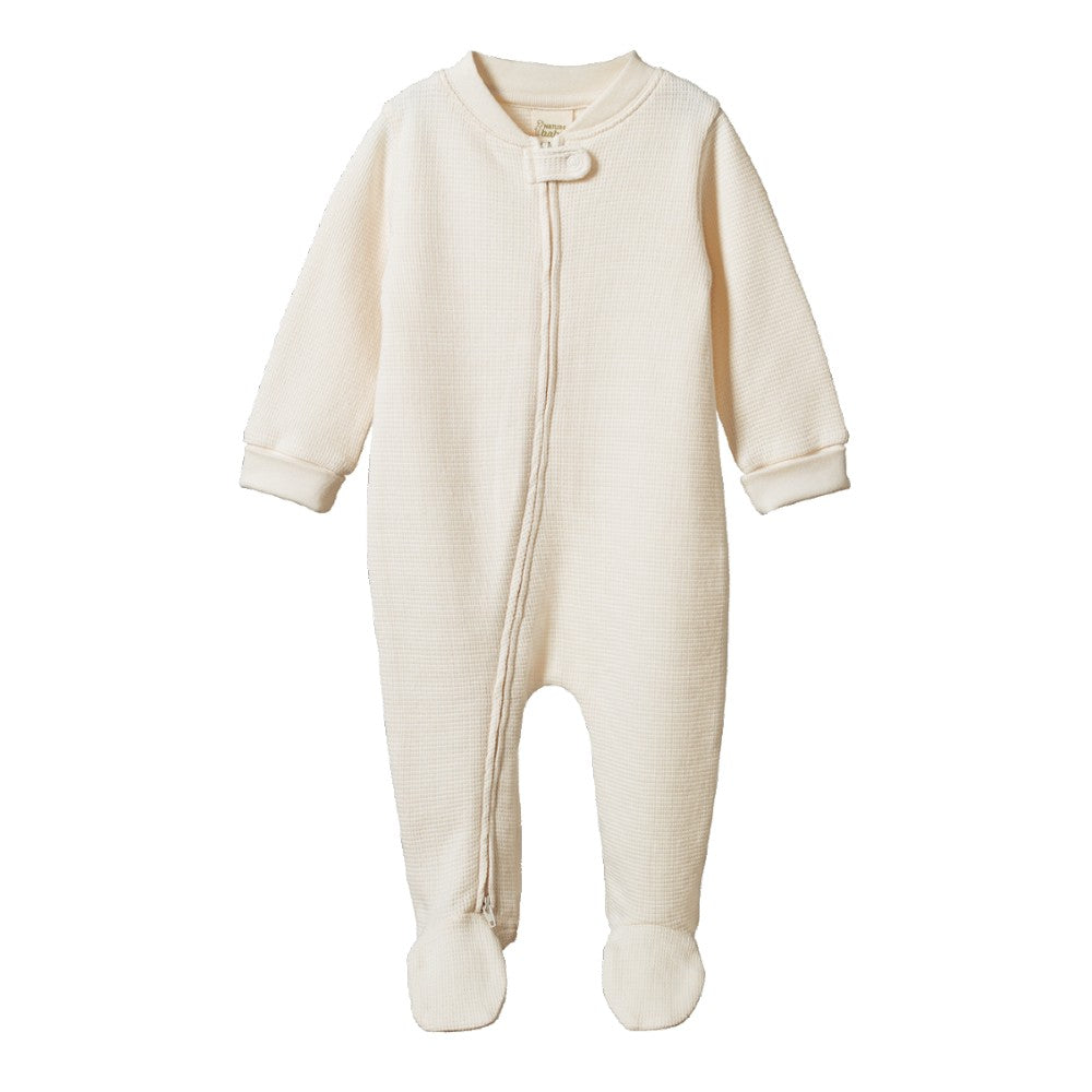 Cream organic cotton waffle texture baby onesie with a zipper and feet on a white background