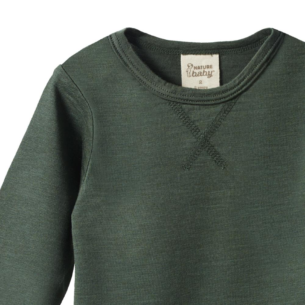 close-up of neckline on a forest Green merino long sleeve top with a nature baby brand label on a white background