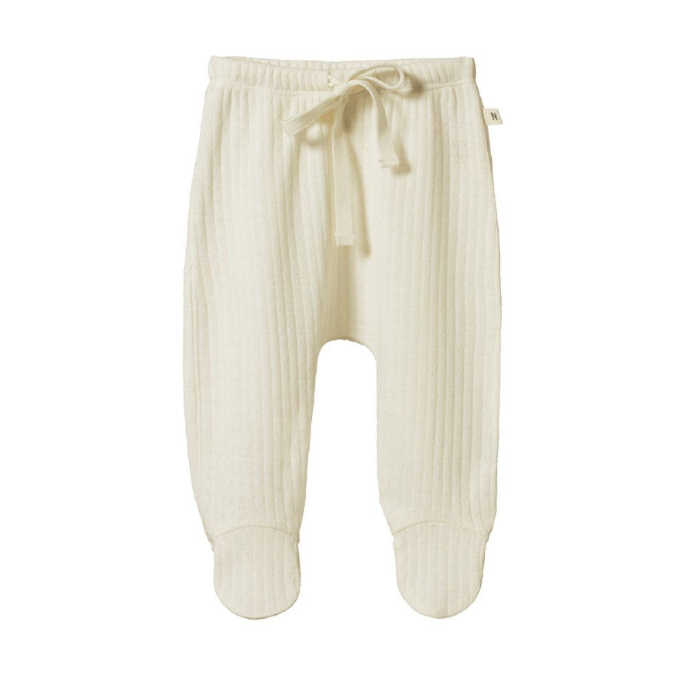 Cream baby merino pointelle footed baby pants with a drawstring on a white background