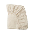 Cream organic cotton jersey fitted sheet on a white background
