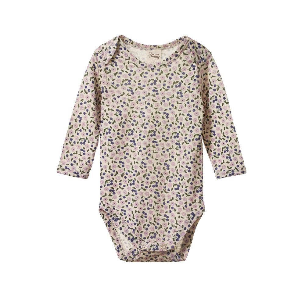 cream and purple floral merino baby bodysuit with long sleeves and envelope neck on a white background