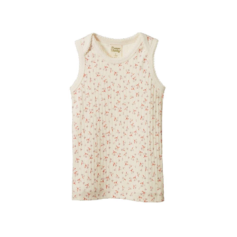 Cotton pointelle singlet with a floral pattern on a white background. 