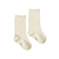 Pair of plain cotton cream coloured socks on a white background