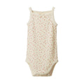 Cotton pointelle singletsuit with a cream base and floral print on a white background. 