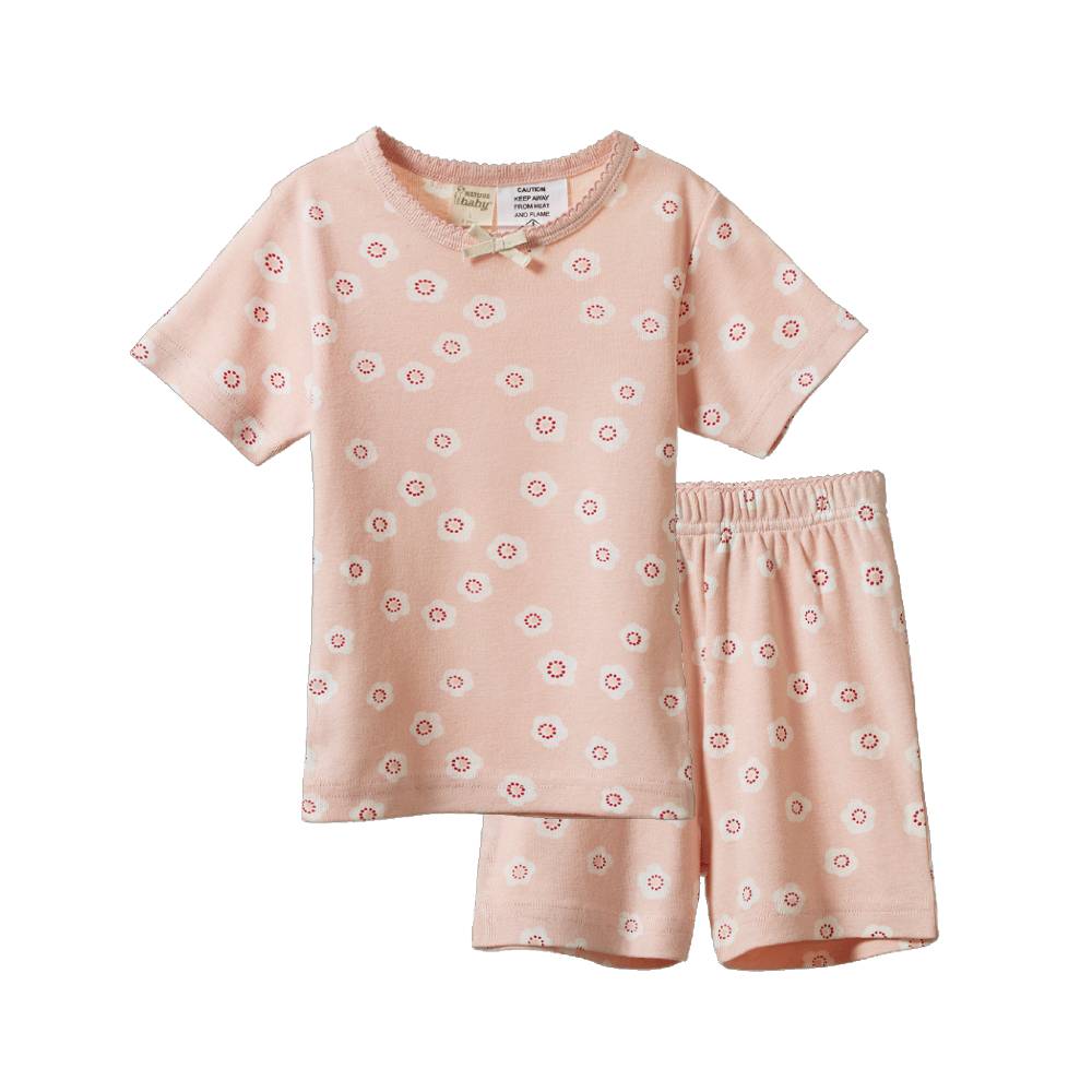 A two-piece baby pajama set consisting of a short-sleeve top and matching shorts in a soft peach-pink color, decorated with a small white and red floral pattern. The top features a scalloped neckline with two decorative wooden beads, and the shorts have an elastic waistband.