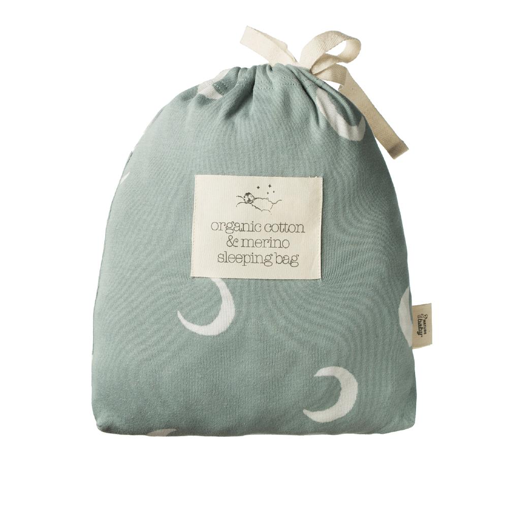 Green organic cotton and merino sleeping bag outer cloth back with moon patterns and label on a white background