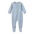 Blue organic cotton jersey baby onesie with zip and white paper aeroplane pattern on a white background