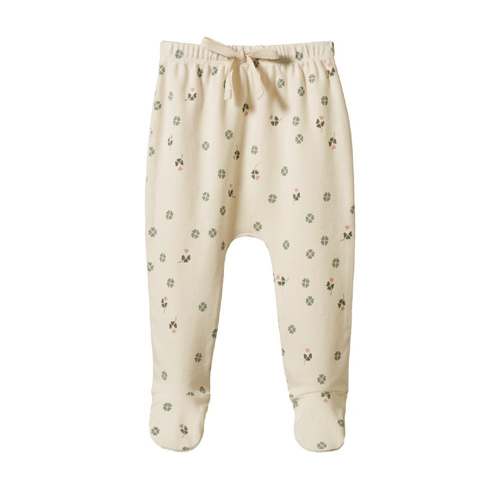 Cream coloured baby footed leggings with green and pink clover pattern on a white background