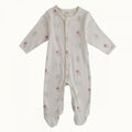 White Baby footed cotton onesie with native new zealand animal patterns on a white background