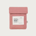 A dusty pink cotton bottom sheet by babu basics, folded and presented flat against a light gray background with a white product label on the front.
