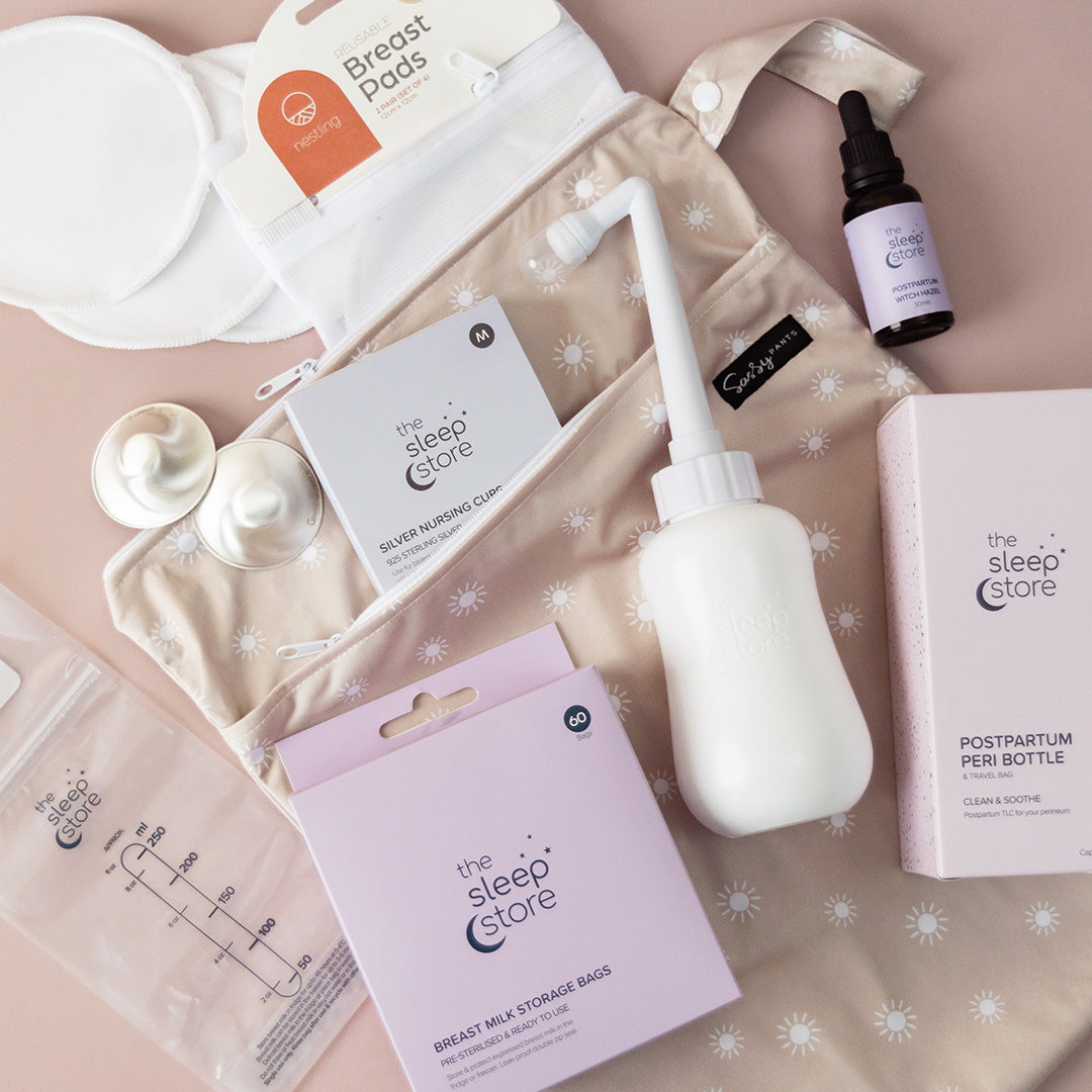 Collection of breastfeeding and postpartum care products by the sleep store on a patterned background