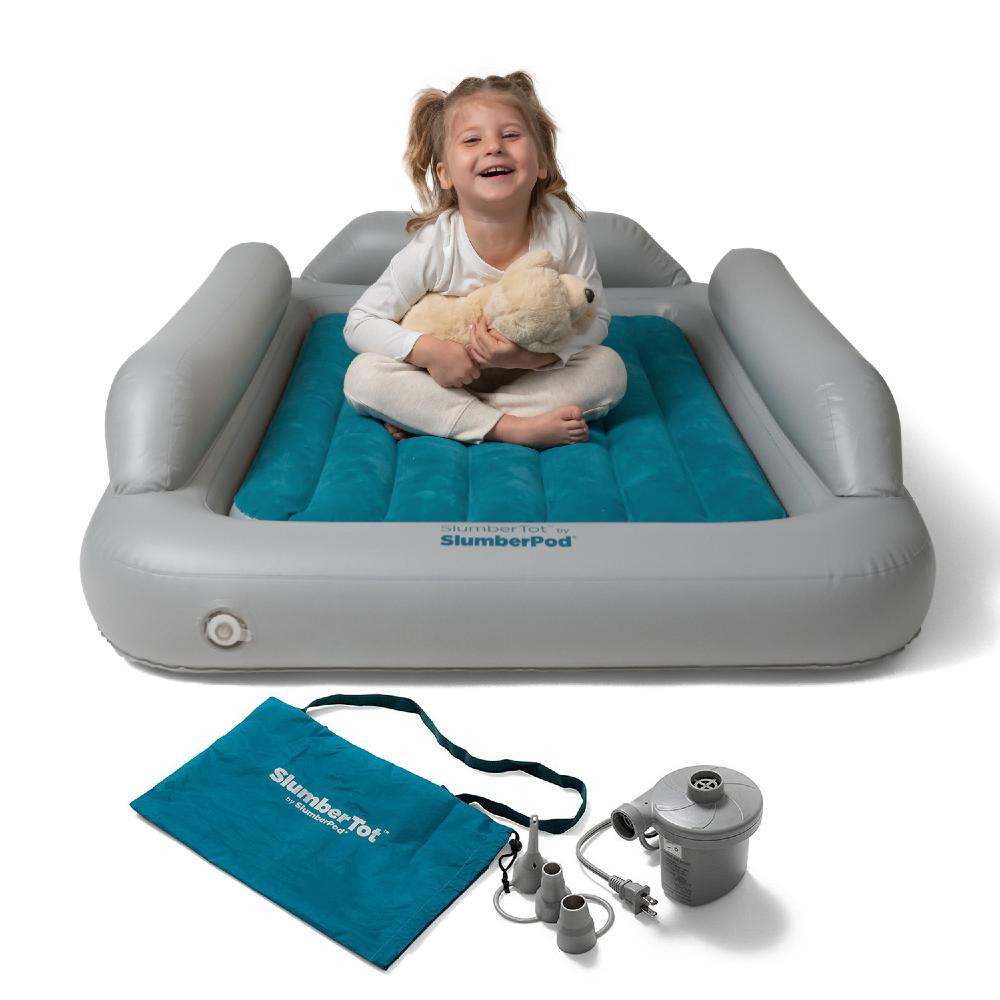 Inflatable SlumberPod with a child sitting on it holding a teddy bear, accompanied by a pump and storage bag.