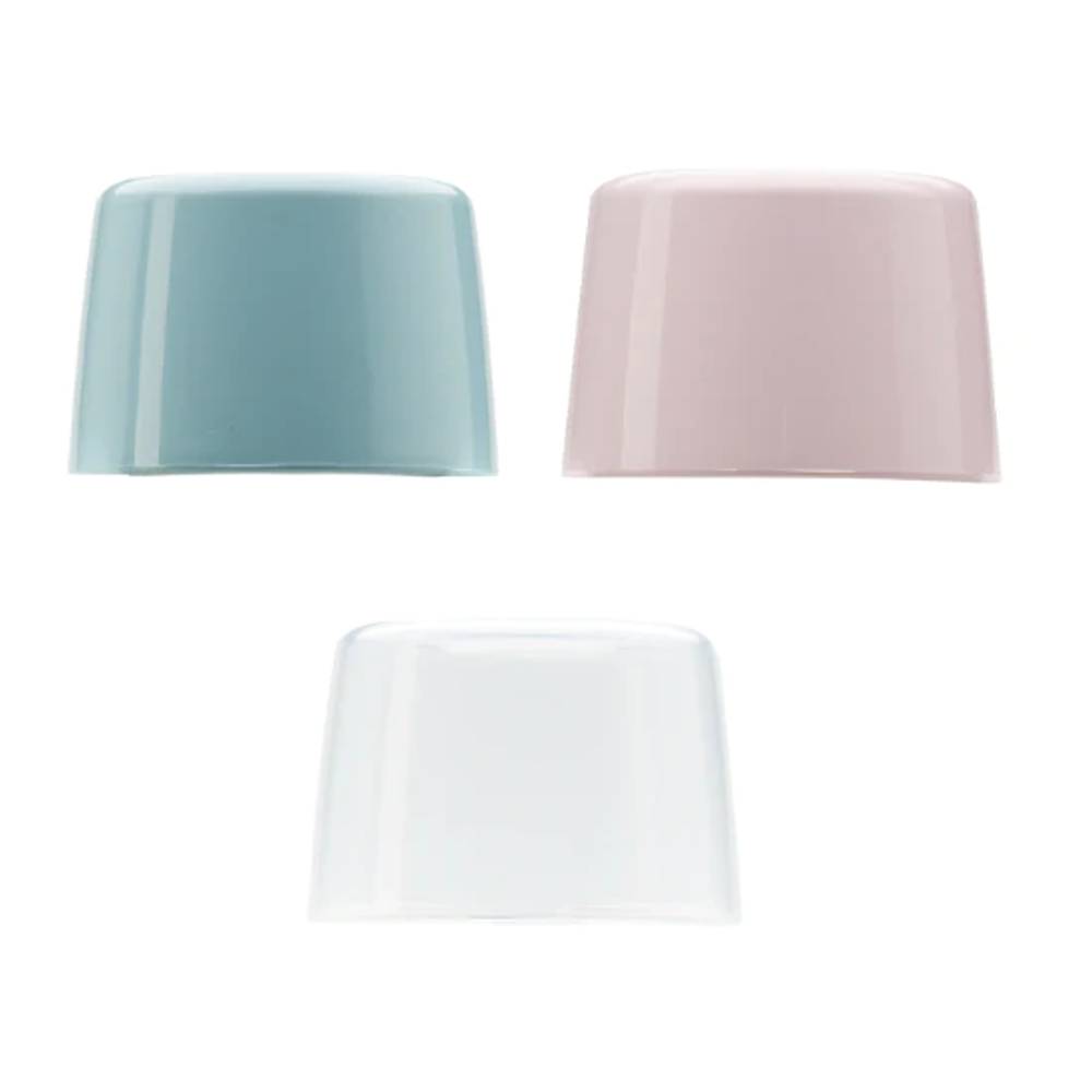 Three food bottle lids in light blue, pink, and clear on a white background