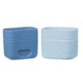 Two blue silicone snack cups with embossed design on a white background