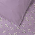 Cotton duvet cover with a lilac base and all over floral print on one side and solid lilac on the other side. 
