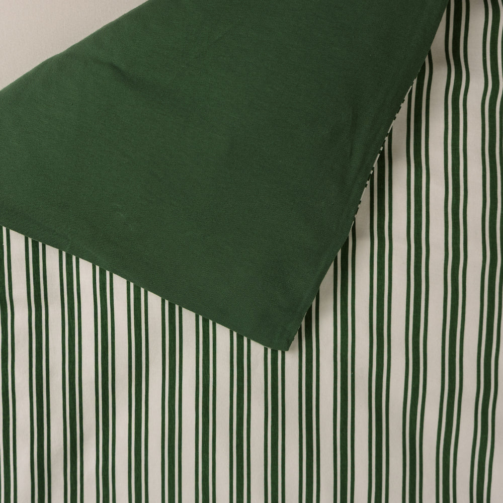 Cotton duvet cover with pine stripe print on one side and solid pine colour on the reverse side. 