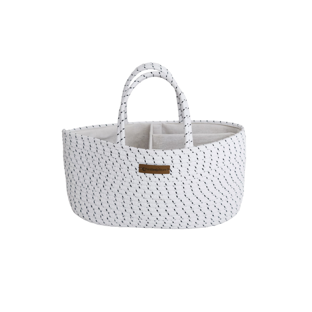 white nappy caddy with black specks and brown brand tag on front