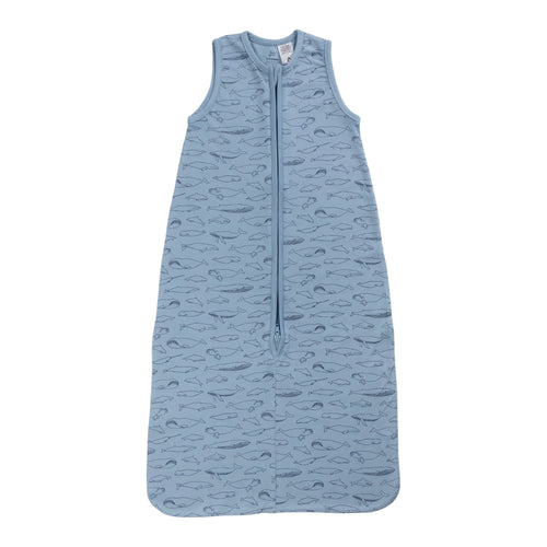 A sleeveless cotton baby sleep sack with blue whales on a blue background, shown flat against a white background.