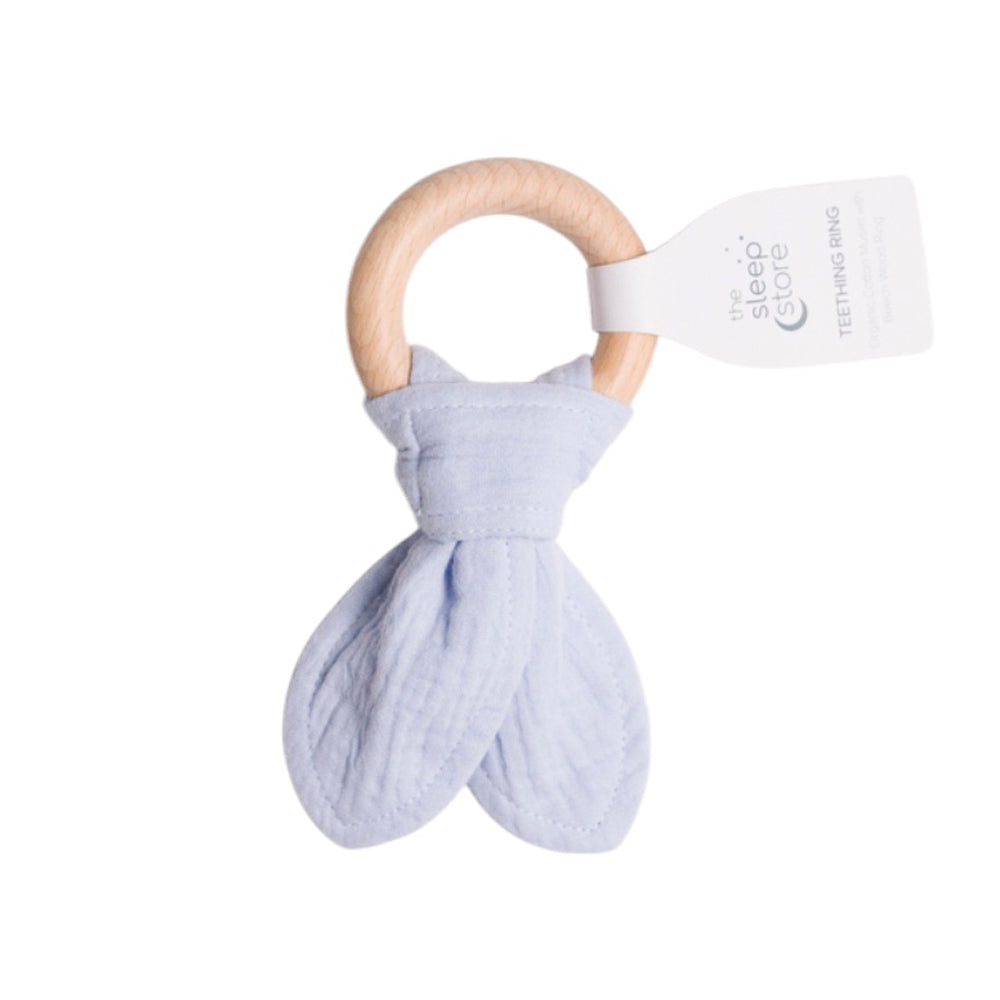 Teething ring with wooden handle and light blue fabric on a white background