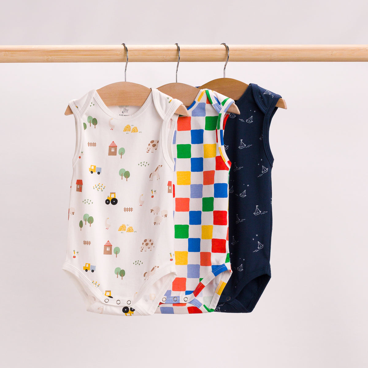 Hanging shot of 3 singlertsuits in farmyard, check and sailboat. 
