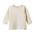Cream waffle textured long-sleeve shirt on a white background