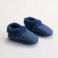 Pair of blue woolbabe lambskin booties with fuzzy trim on a white background