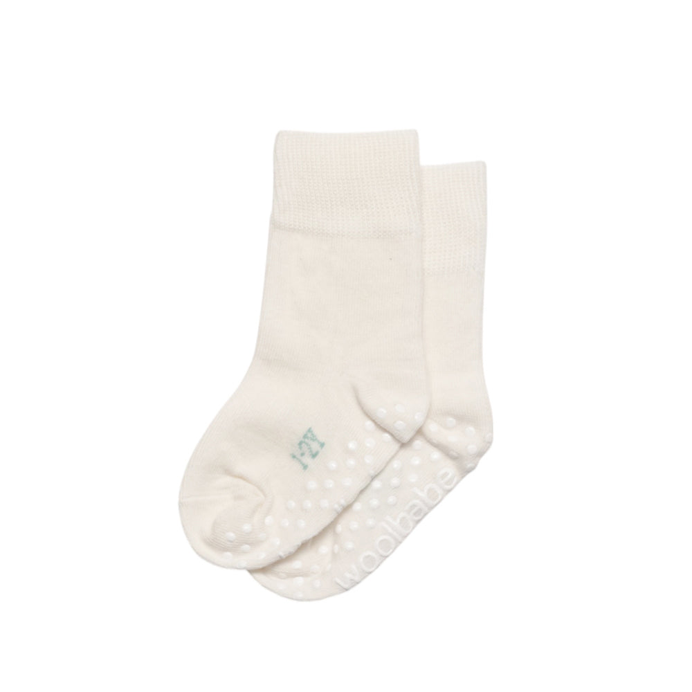 White baby sock with grippy sole on a white background