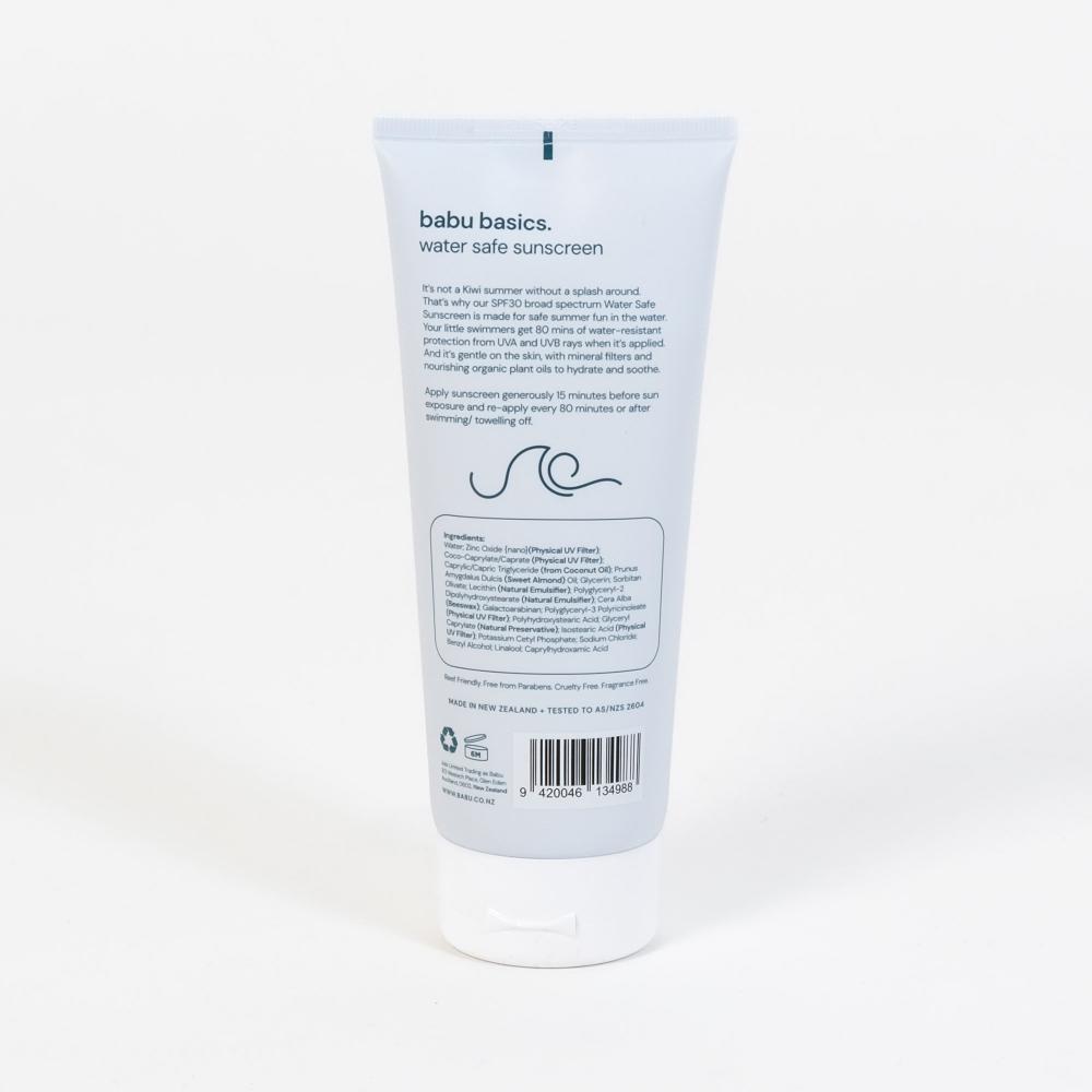 The back of a white squeeze tube of babu basics water safe sunscreen, showing the product details, barcode, and text on a clean white background.