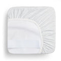 A waterproof fitted sheet shown on a mattress in Midnight Stripe pattern
