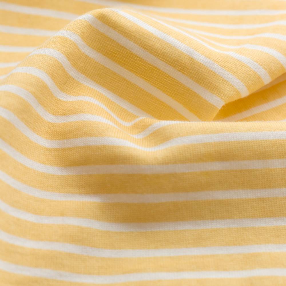 Close-up of yellow fabric with white stripes
